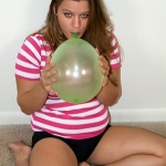 Winsome blonde teen dish Christy playing with balloons on the floor
