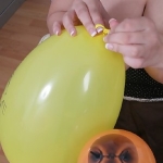 Board bosomy girl at work playing with balloons